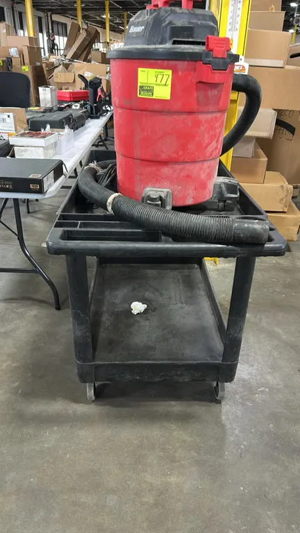 Poly 2-tier utility cart. Features molded push handle with integrated storage compartments and (2) lipped shelves. 44"L. Mounted on casters. Note: Vac