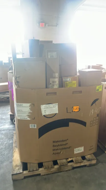 Assorted Ford OEM automotive parts in Gaylord container. Includes engine wiring harness (JU5Z-12A581-C), automatic transmission flexplate (HL3Z-6375-A