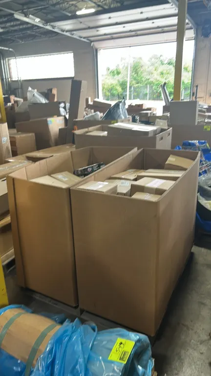 Pallet lot of assorted genuine Ford and Motorcraft automotive parts in Gaylord containers. Includes EGR valve spacer plate (P/N: DC3Z 9U433 A), high m
