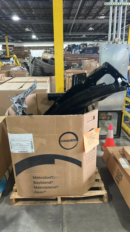 Genuine Ford OEM automotive body parts lot. Includes tailgate gap cover (P/N: FL3Z-9943121-A), cowl panel (P/N: BB5Z-7802010-A), front upper bumper im