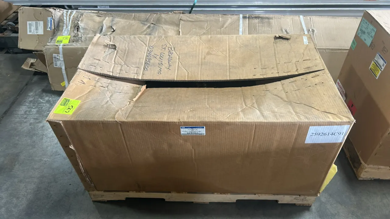 Ford OEM fuel tank assembly, part number 5C4Z-9002-JB. Stored in original manufacturer packaging. Mounted on a wooden shipping pallet.