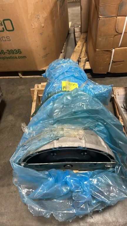 Ford automatic transmission assembly. Features integrated bellhousing, torque converter with retaining bracket, and protective wrapping. Includes loos