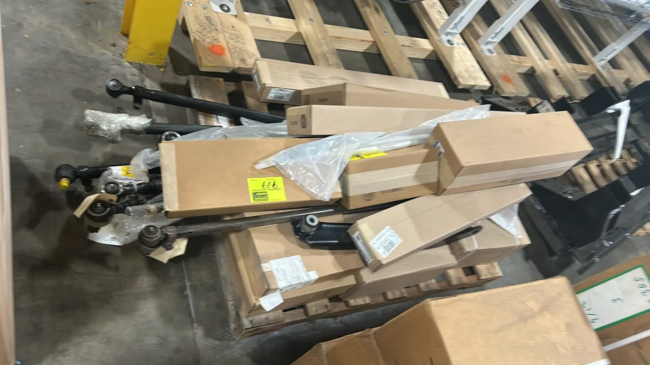Pallet lot of Ford OEM automotive parts. Includes front lower bumper grille (P/N EG1Z 17K945 CA), windshield moldings (P/N LB5Z-7803145-AB), engine wi