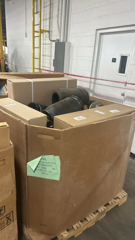 Assorted automotive and heavy-duty truck parts in Gaylord container. Includes OEM Ford upper radiator fan shroud (P/N: LC3Z-8146-E), OEM Ford air defl