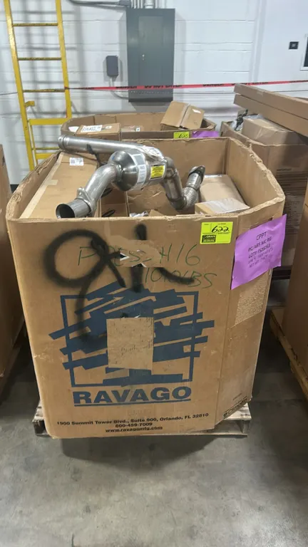 Ford automotive parts lot in Gaylord container. Includes genuine Ford catalytic converter assembly (P/N: JL1Z-5E212-J), radiator assembly (P/N: LU9Z-8