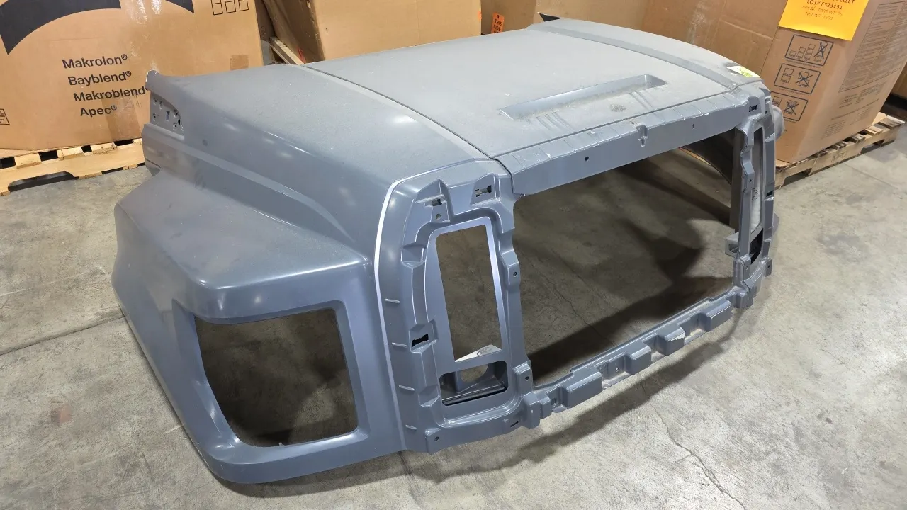 Ford OEM medium-duty truck front hood shell. Features gray exterior finish, integrated front fenders, and factory cutouts for center grille and headla