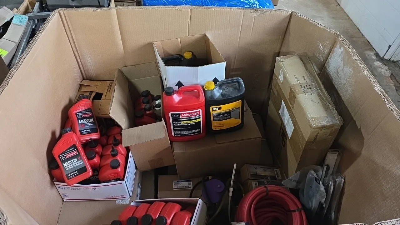 Assorted automotive fluids, air hose, and parts lot. Includes Motorcraft Mercon V and Mercon LV transmission fluid, Motorcraft yellow concentrated coo