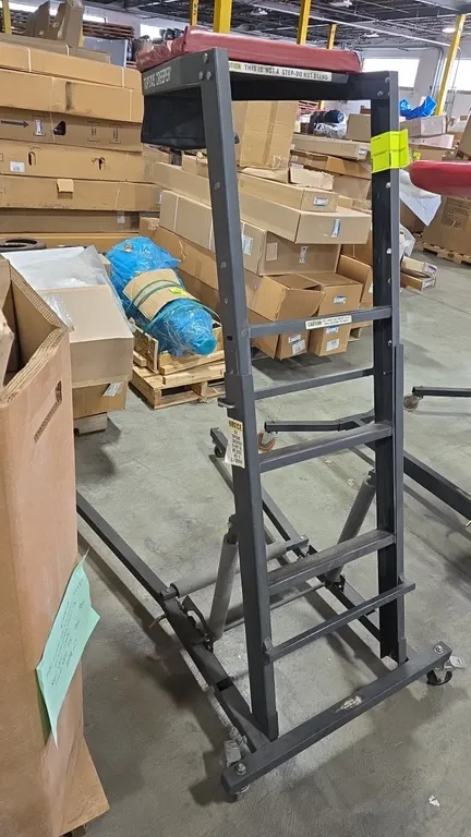Topside Creeper adjustable topside creeper. Features a padded chest rest with attached tool pouch, integrated ladder steps, and height-adjustable stee