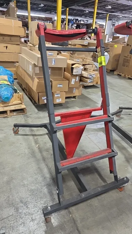 ProGear topside creeper. Features adjustable height, integrated ladder steps, and padded support deck. Mounted on swivel casters. Note: Padded cushion