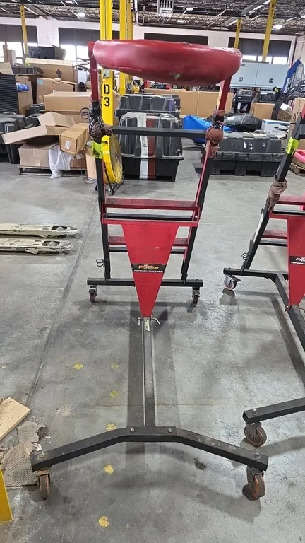 ProGear portable topside creeper. Features adjustable height ladder frame, padded red vinyl deck, and steel construction. Mounted on swivel casters. N