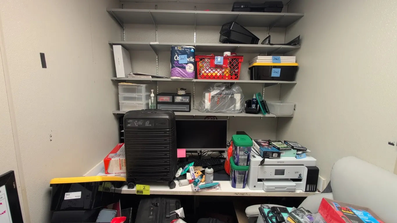 Laminate office workstation suite. Includes 6' laminate desk, 6' laminate 4-tier wall-mounted shelving unit, 4' metal-framed cork board, and 3' wood-f