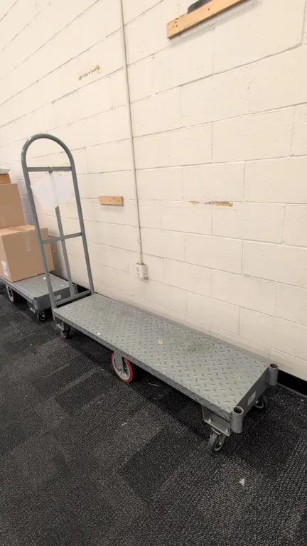 Metal 6-wheel U-boat cart. Features diamond plate steel deck and single removable tubular steel end handle. 5'L. Mounted on (2) rigid center wheels an