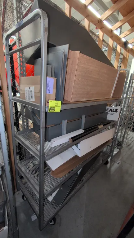 Metal 4-tier rack cart. Features expanded metal shelves and integrated tubular push handles. 68"L x 21"W x 70"H. Mounted on casters. Contents not incl