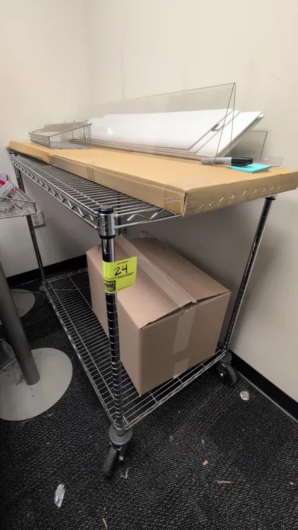 Metal 2-tier wire utility cart. Features chrome finish and two wire shelves. 42"L x 24"W x 38"H. Mounted on swivel casters. Contents not included.