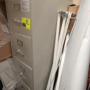 Metal 4-drawer vertical filing cabinet. Features putty finish, chrome pull handles, integrated label holders, and top lock mechanism. 15" x 52". Conte