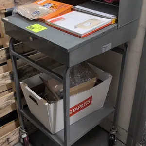 Win-Holt metal portable desk. Features an upper organizer shelf, hinged lift-top storage compartment, and lower utility shelf. 24" x 49"H. Mounted on 