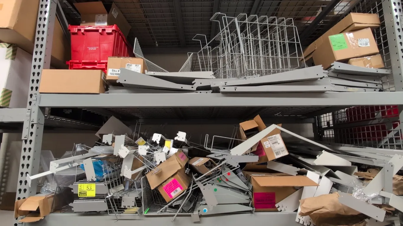 Assorted shelving components and accessories. Includes metal shelf brackets, wire display dividers, metal shelves, and boxed retail fixture parts. Not