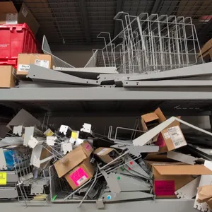Assorted shelving components and accessories. Includes metal shelf brackets, wire display dividers, metal shelves, and boxed retail fixture parts. Not