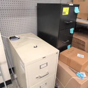 Metal vertical filing cabinets. Includes (1) Staples 2-drawer filing cabinet in putty finish (15" x 29") and (1) 4-drawer filing cabinet in black fini