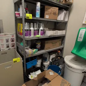 5-tier metal shelving rack. Includes cleaning supply contents featuring spray chemicals, cleaners, paper products, and mop heads as pictured. 48"L x 1