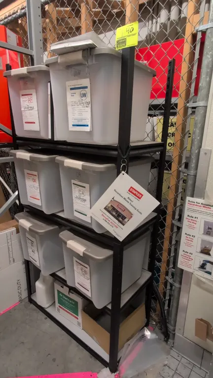 Metal 4-tier shelving rack. Features black metal construction with four storage shelf levels. Dimensions: 36"x18"x72". Contents not included.