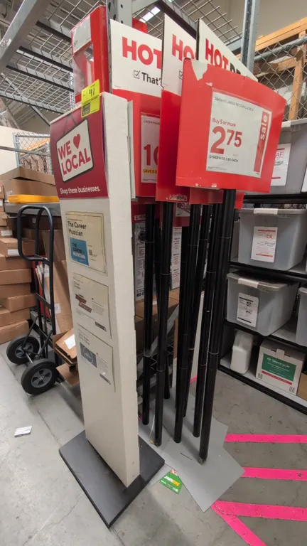 Assorted retail sign stands. Includes (1) freestanding floor directory tower display with slot inserts and weighted base, and multiple upright metal p
