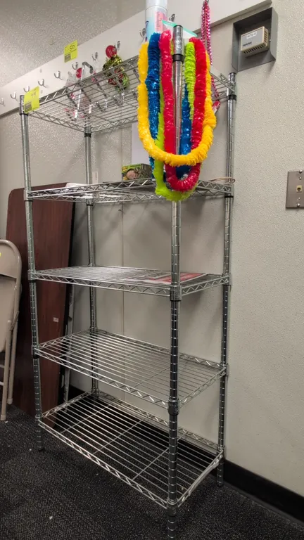 Metal 5-tier wire shelving rack. Features 5 adjustable wire shelves and chrome finish. Dimensions: 30"x14"x60". Contents not included.