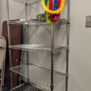 Metal 5-tier wire shelving rack. Features 5 adjustable wire shelves and chrome finish. Dimensions: 30"x14"x60". Contents not included.