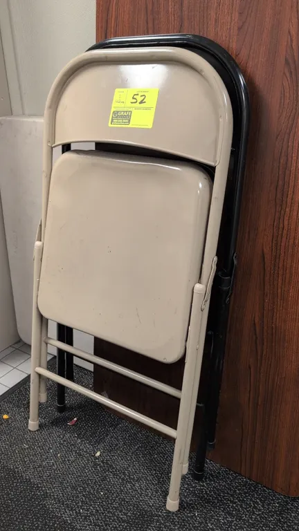 Assorted metal folding chairs. Includes (1) beige painted steel folding chair and (1) black folding chair with padded vinyl seat and backrest. Feature