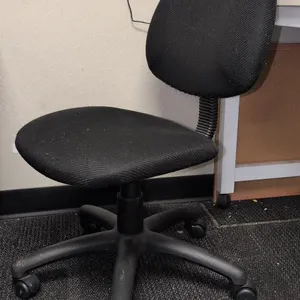 Assorted office chairs. Includes (1) black mesh-back task chair with arms, (1) black fabric armless task chair, and (1) gray fabric armless task chair