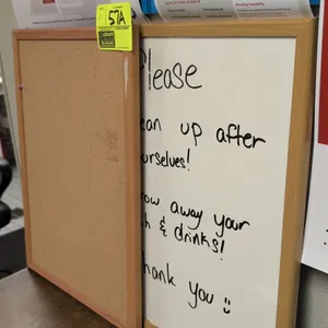 Staples wood-framed cork bulletin board and dry-erase whiteboard. Features natural wood-finish frames. 17" x 23" each.