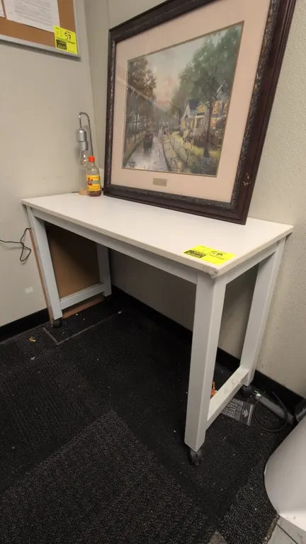 Laminate portable table. Features a white laminate top and metal frame. 42"L. Mounted on casters. Tabletop items not included.