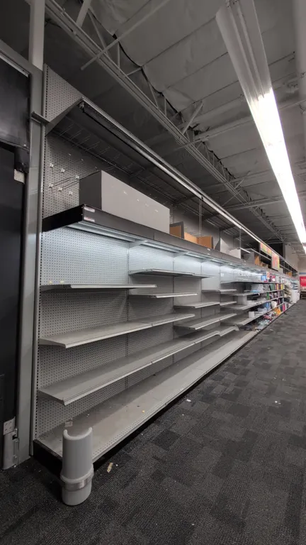 88'L of Madix wall shelving. 144"H uprights with 24"D base shelves. Features gray finish, pegboard backing, integrated canopy lighting, and vinyl pull