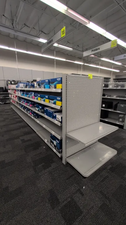 43'L of Madix gondola shelving. 60"H uprights with 18"/18" base shelves. Features grey finish, pegboard backing, and adjustable upper shelves. Content