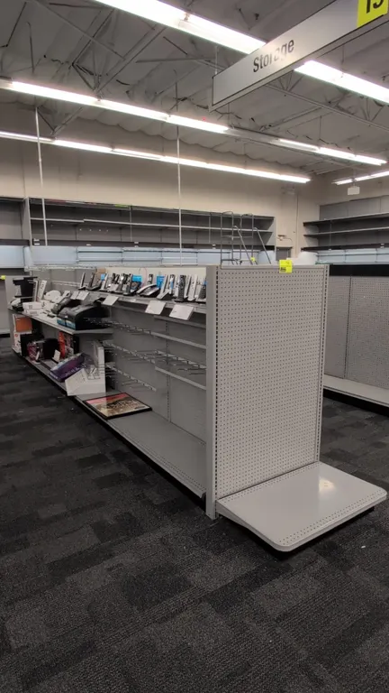 43'L of Madix gondola shelving. 60"H uprights with 18"/18" base shelves. Features gray finish, pegboard backing, and adjustable upper shelving. Conten