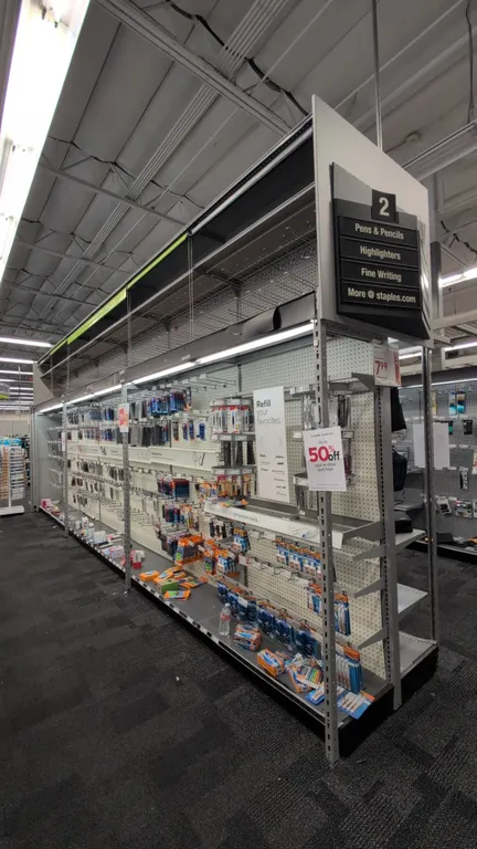 52'L of Madix gondola shelving. 120"H uprights with 18"/18" base shelves. Features gray finish, pegboard backing, integrated overhead lighting, vinyl