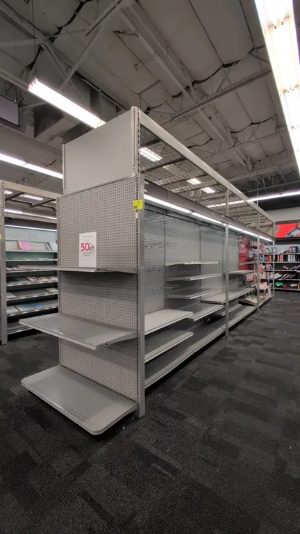 52'L of Madix gondola shelving. 108"H uprights with 18"D base shelves. Features gray finish, pegboard backing, integrated canopy lighting, and adjusta