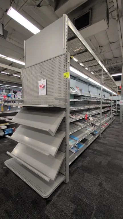 52'L of Madix gondola shelving. 108"H uprights with 18"/18" base shelves. Features gray finish, pegboard backing, adjustable shelving, top overhead wi