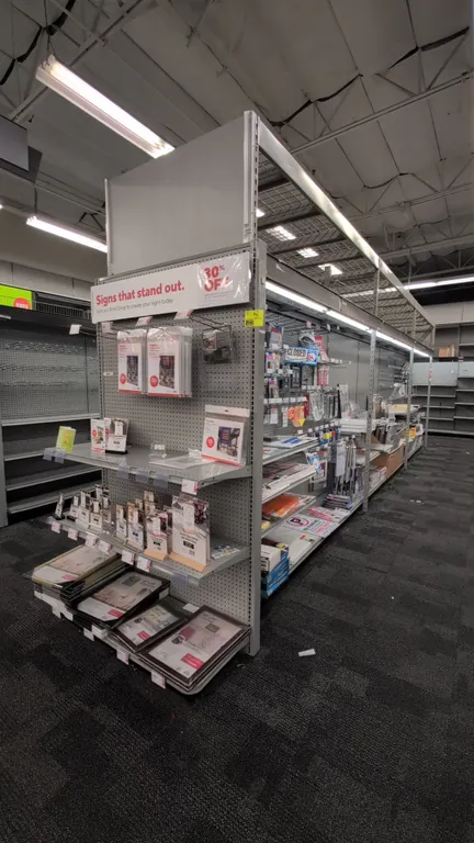 52'L of Madix gondola shelving. 108"H uprights with 18"/18" base shelves. Features gray pegboard backing, overhead structure with integrated canopy li