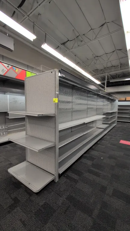 52'L of Madix gondola shelving. 84"H uprights with 18"/18" base shelves. Features gray finish, pegboard backing, adjustable upper shelves, and integra