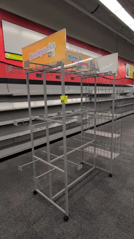 Metal 4-sided portable merchandise display rack. Features hanging display hooks, side wire grid shelving, and upper signage holders. 73"W x 30"D x 85"