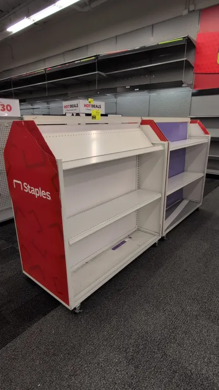 Metal portable double-sided merchandise display racks. Features adjustable metal shelving, angled top shelf, and graphic end panels. Dimensions: 51"L