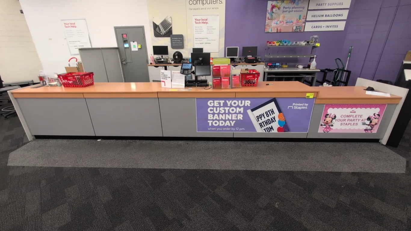 Laminate service counter with under-counter shelving. Features wood-look laminate countertop with split-level surface, built-in storage drawers, lower