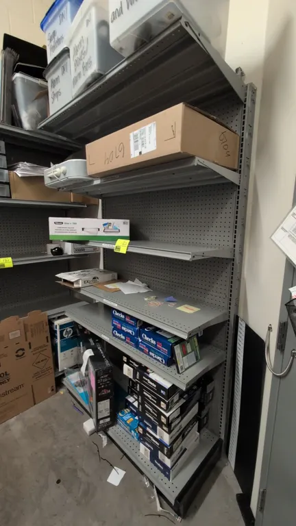 4'L of Madix wall shelving. 7'H uprights with 2'D base shelf. Features gray finish, pegboard backing, and adjustable metal shelving. Includes (2) addi