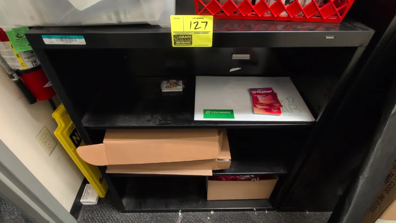 Metal 3-tier shelving rack. Features black metal construction with two interior shelves. Dimensions: 34"W x 14"D x 40"H. Contents not included.