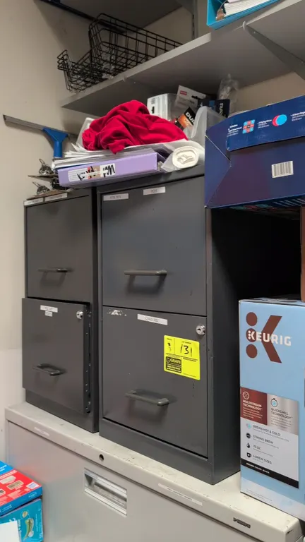 Metal 2-drawer filing cabinets. Features steel construction, cylinder locks, and pull handles. 14" x 24". Includes gray stationary units and a blue un