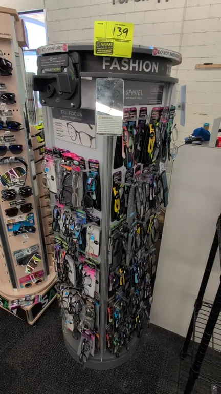 Portable rotating sunglasses merchandise display rack. Features poly and metal construction, multi-sided eyewear display holders, integrated side mirr