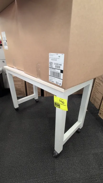 Laminate portable table. Features a white laminate top and white metal frame. 36". Mounted on casters. Boxes not included.