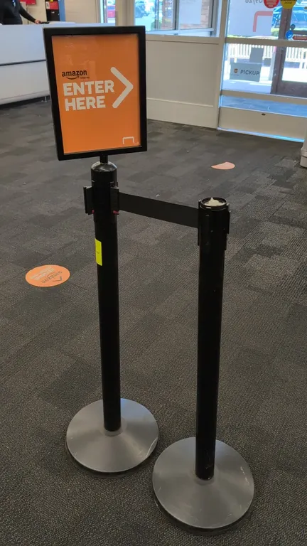 Retractable belt crowd control stanchions. Features black posts, retractable belts, circular weighted bases, and (1) top-mounted sign frame. 40"H. Not