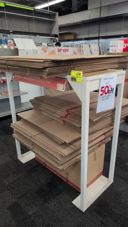 Metal merchandise display rack. Features white-finished metal frame construction with an open two-tier design. Dimensions: 46" x 21" x 49". Contents n